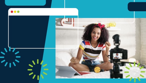 a person sitting on a bed with a tablet, smiling at a camera